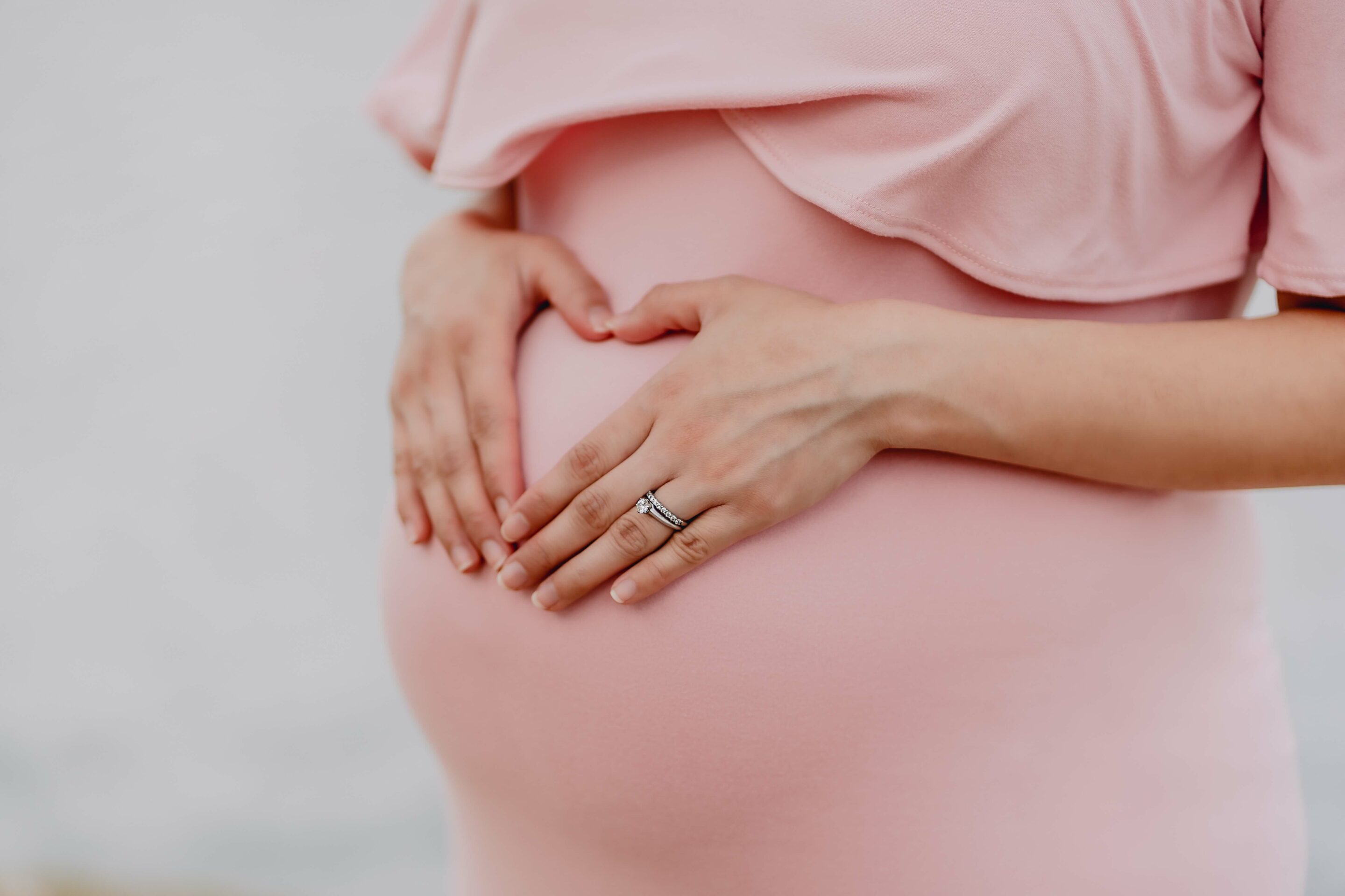 pregnant worker with hands on belly