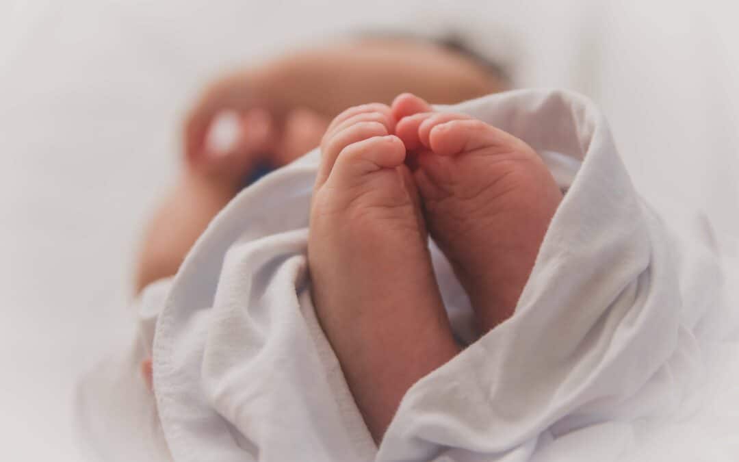 newborn feet up close. newborns need insurance coverage